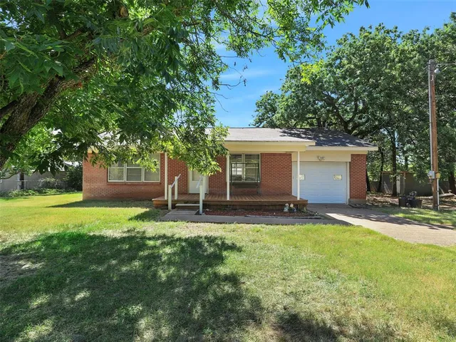 a backyard of a house with yard and outdoor seating