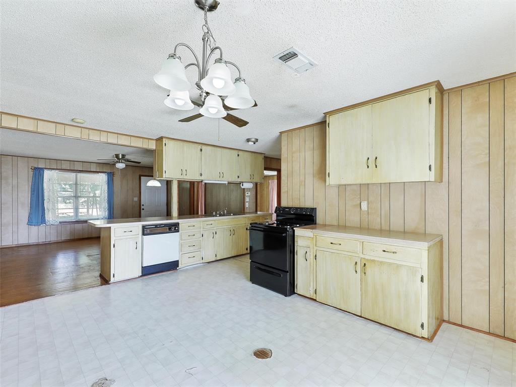 404 Selma Road Bowie, TX 76230 - Photo 12 of 21 a large kitchen with a large counter space cabinets and stainless steel appliances