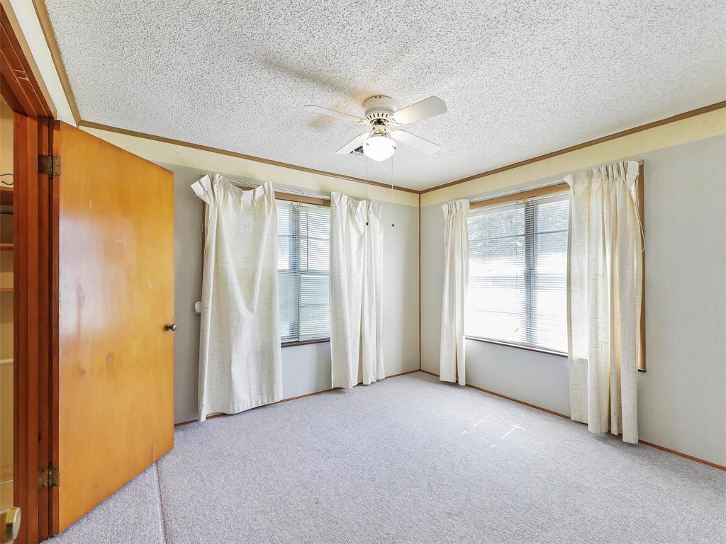 404 Selma Road Bowie, TX 76230 - Photo 16 of 21 an empty room with windows and closet