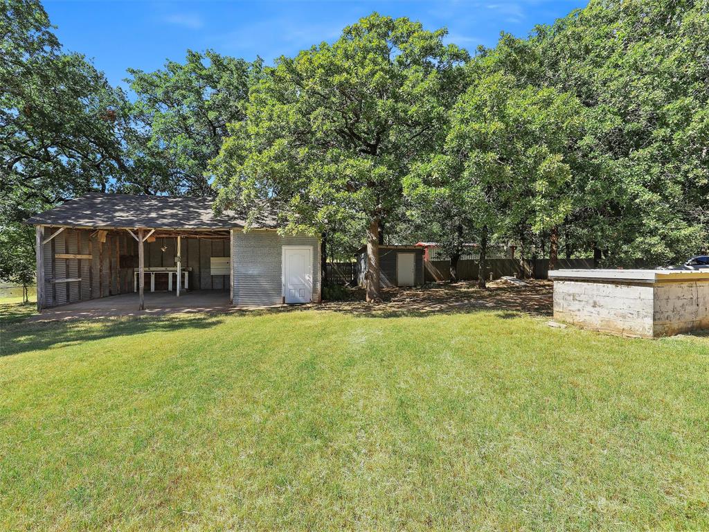 404 Selma Road Bowie, TX 76230 - Photo 18 of 21 a backyard of a house with table and chairs