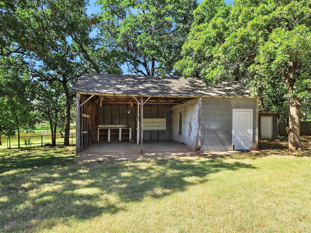 404 Selma Road Bowie, TX 76230 - Photo 19 of 21 a view of a house with a yard and tree s