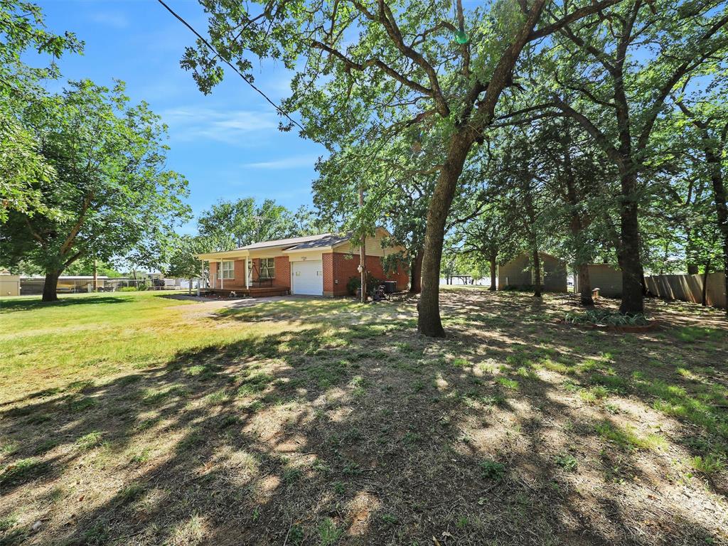 404 Selma Road Bowie, TX 76230 - Photo 2 of 21 a view of a house with a yard