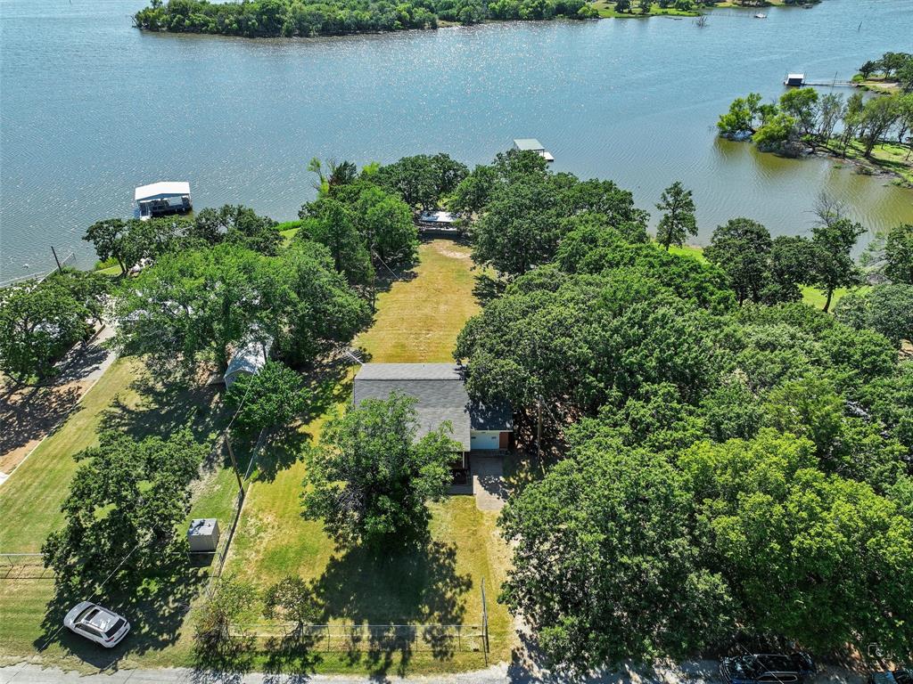 404 Selma Road Bowie, TX 76230 - Photo 3 of 21 an aerial view of a house with a yard and lake view