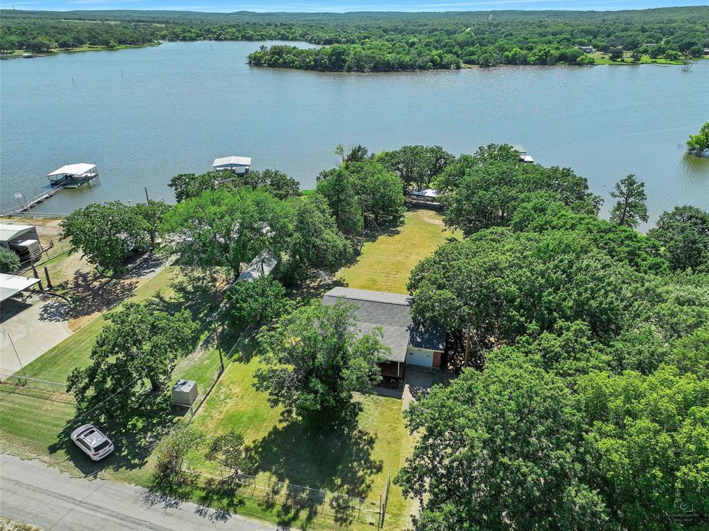 404 Selma Road Bowie, TX 76230 - Photo 7 of 21 an aerial view of a residential houses with outdoor space and lake view