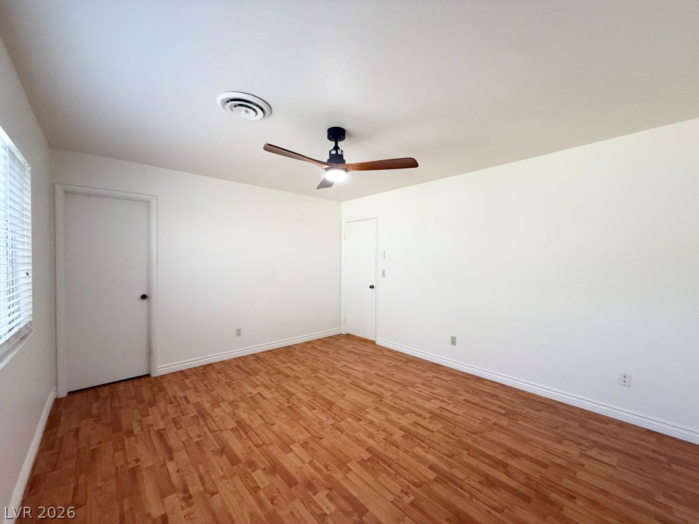 616 Greenway Road Henderson, NV 89002 - Photo 17 of 32 A versatile room with durable laminate flooring and a ceiling fan, ready for personal touches.