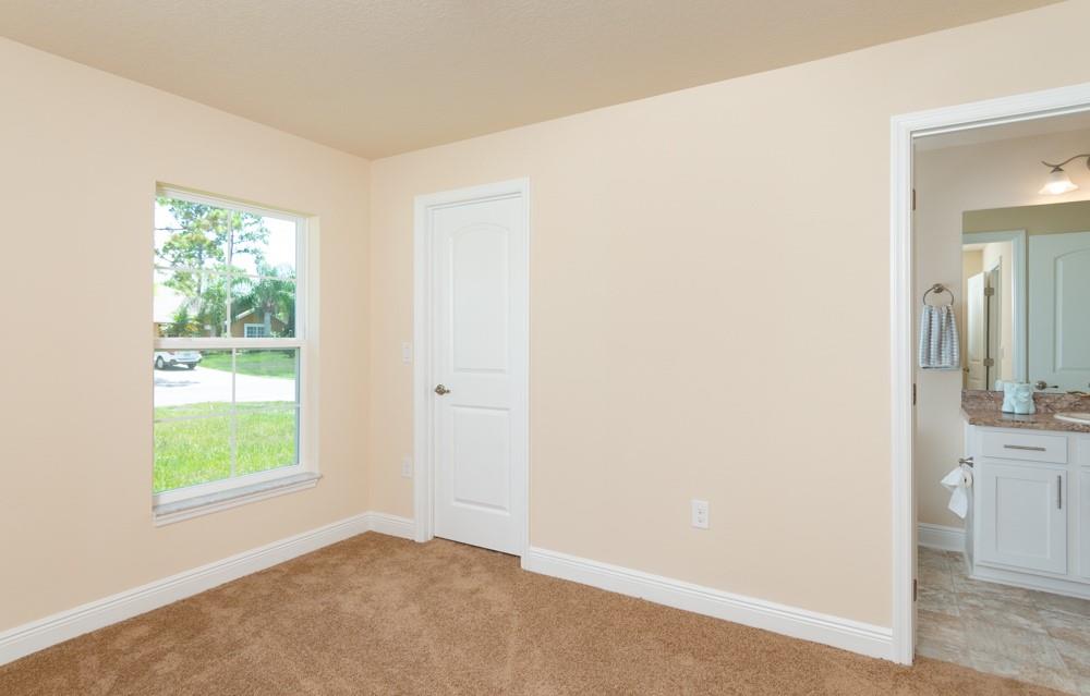 1391 Seahouse Street Sebastian, FL 32958 - Photo 12 of 18 an empty room with windows and closet