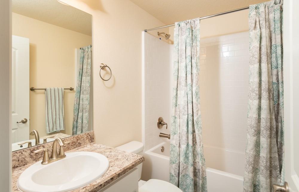 1391 Seahouse Street Sebastian, FL 32958 - Photo 14 of 18 a bathroom with a granite countertop sink toilet and shower