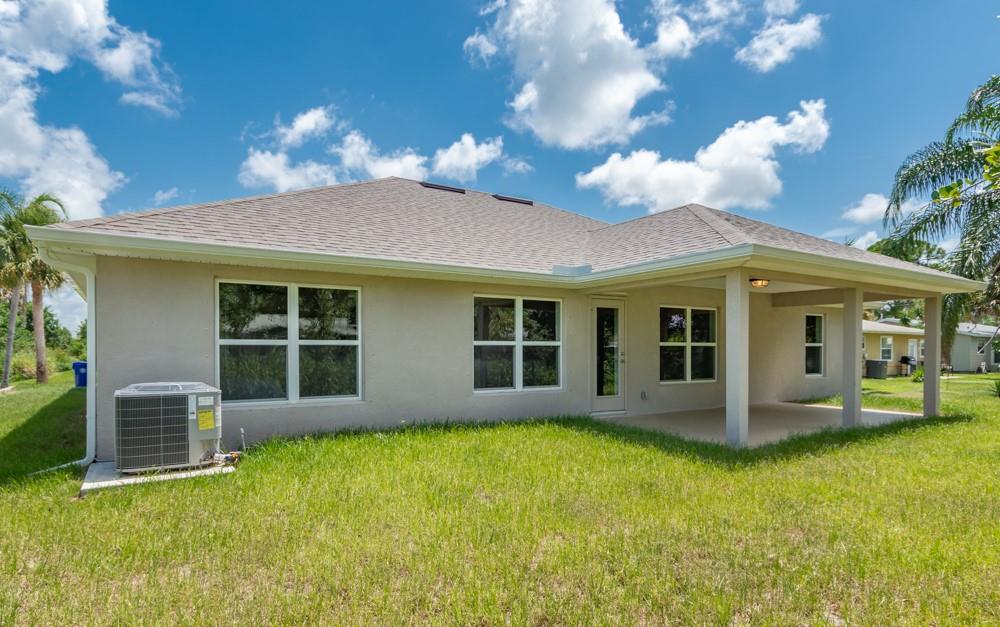 1391 Seahouse Street Sebastian, FL 32958 - Photo 18 of 18 a view of a house with a garden and yard