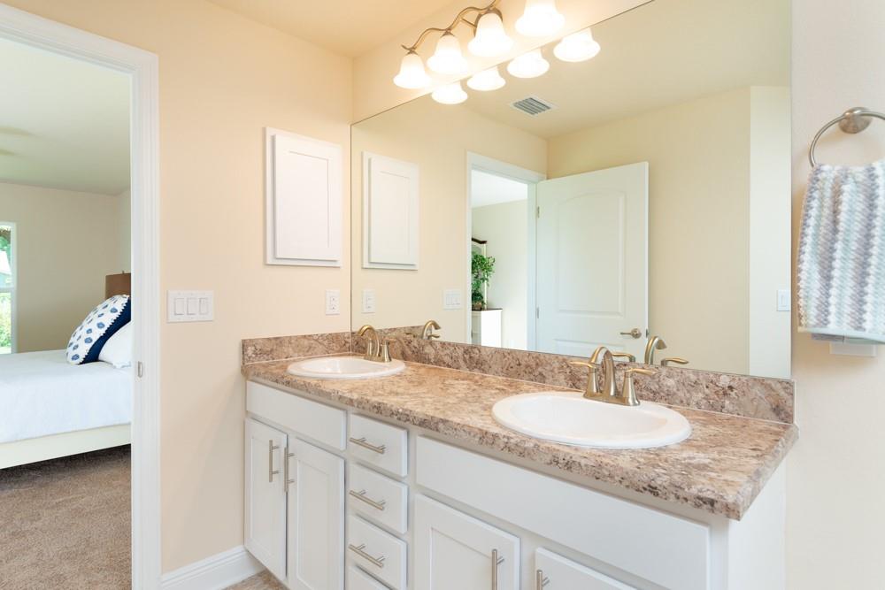 1391 Seahouse Street Sebastian, FL 32958 - Photo 4 of 18 a bathroom with a granite countertop sink and a mirror