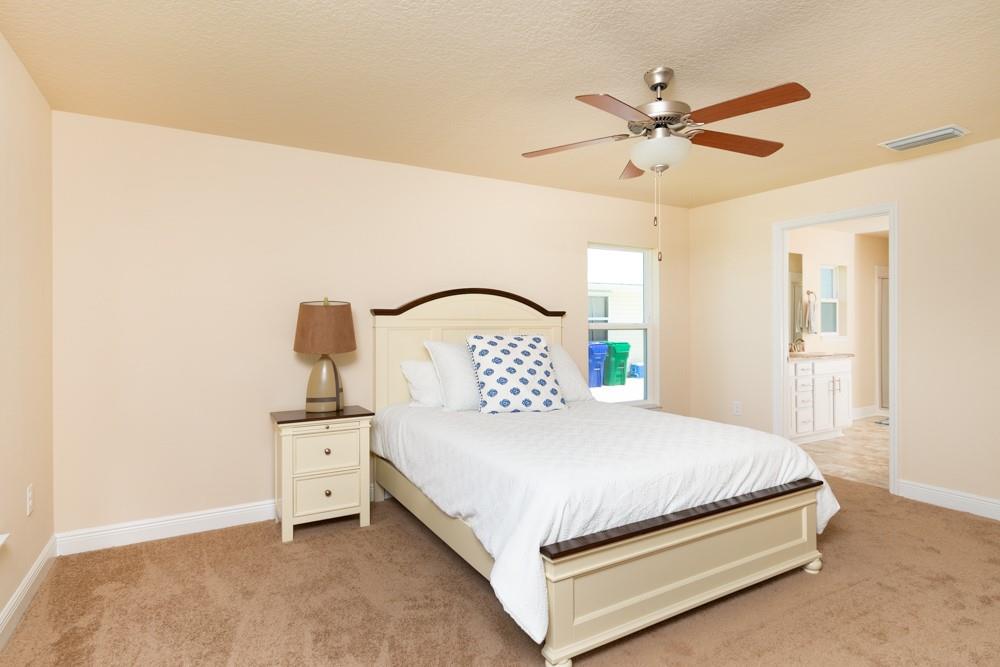 1391 Seahouse Street Sebastian, FL 32958 - Photo 6 of 18 a bedroom with a bed and a painting on the wall