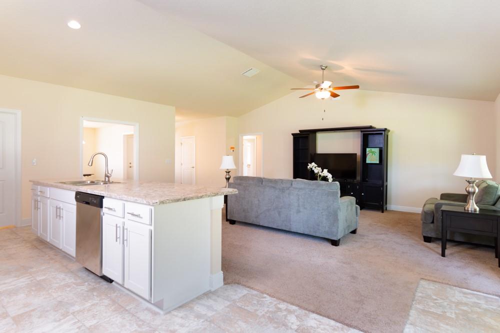 1391 Seahouse Street Sebastian, FL 32958 - Photo 7 of 18 a living room with furniture and a chandelier