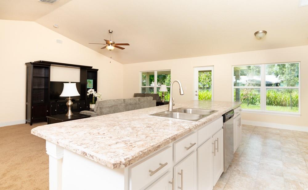 1391 Seahouse Street Sebastian, FL 32958 - Photo 10 of 18 a kitchen with a stove a sink and a refrigerator