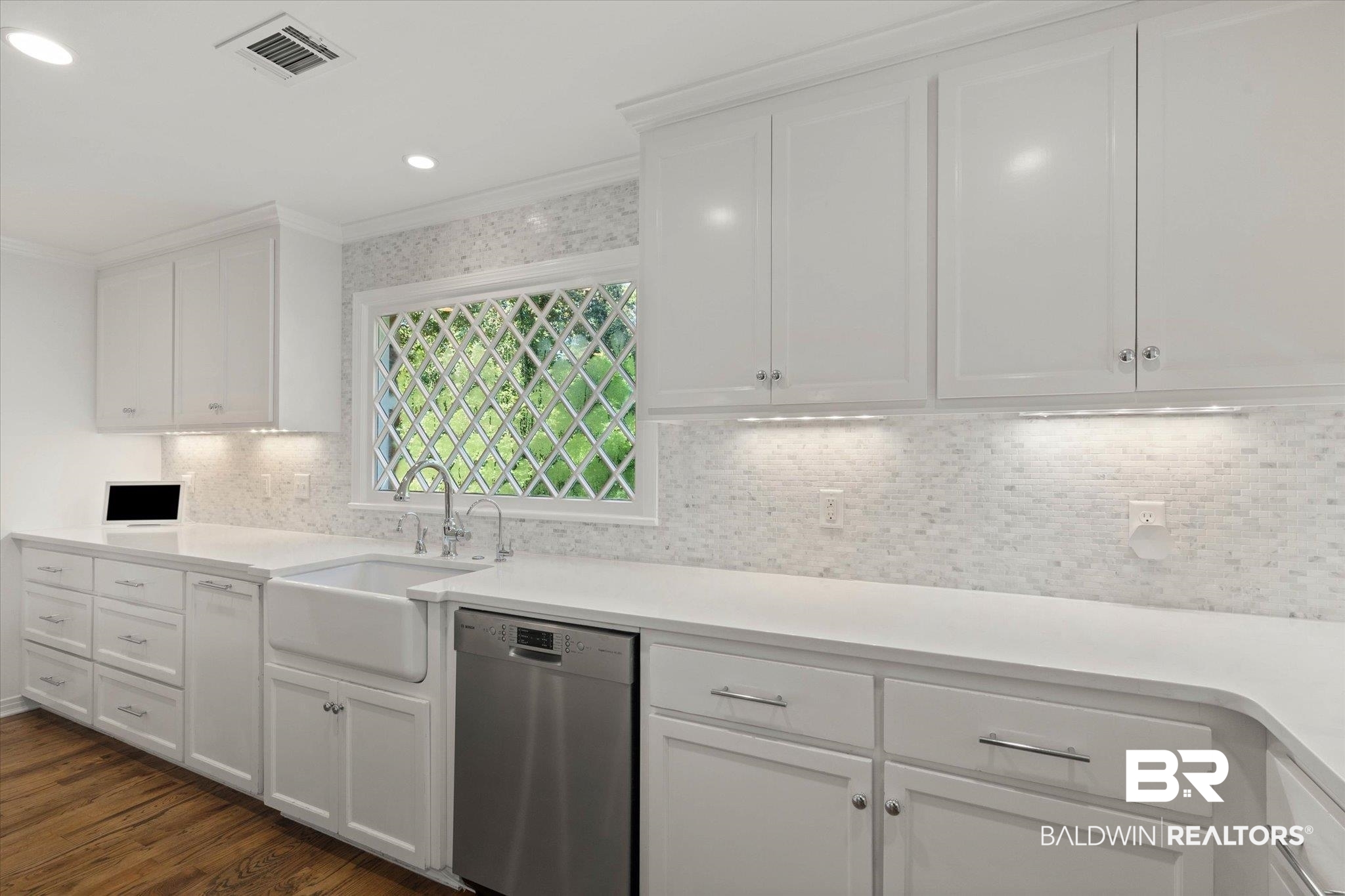 3612 Linden Lane Mobile, AL 36608 - Photo 14 of 42 Kitchen featuring backsplash, dishwasher, white cabinets, dark wood-style flooring, and ornamental molding