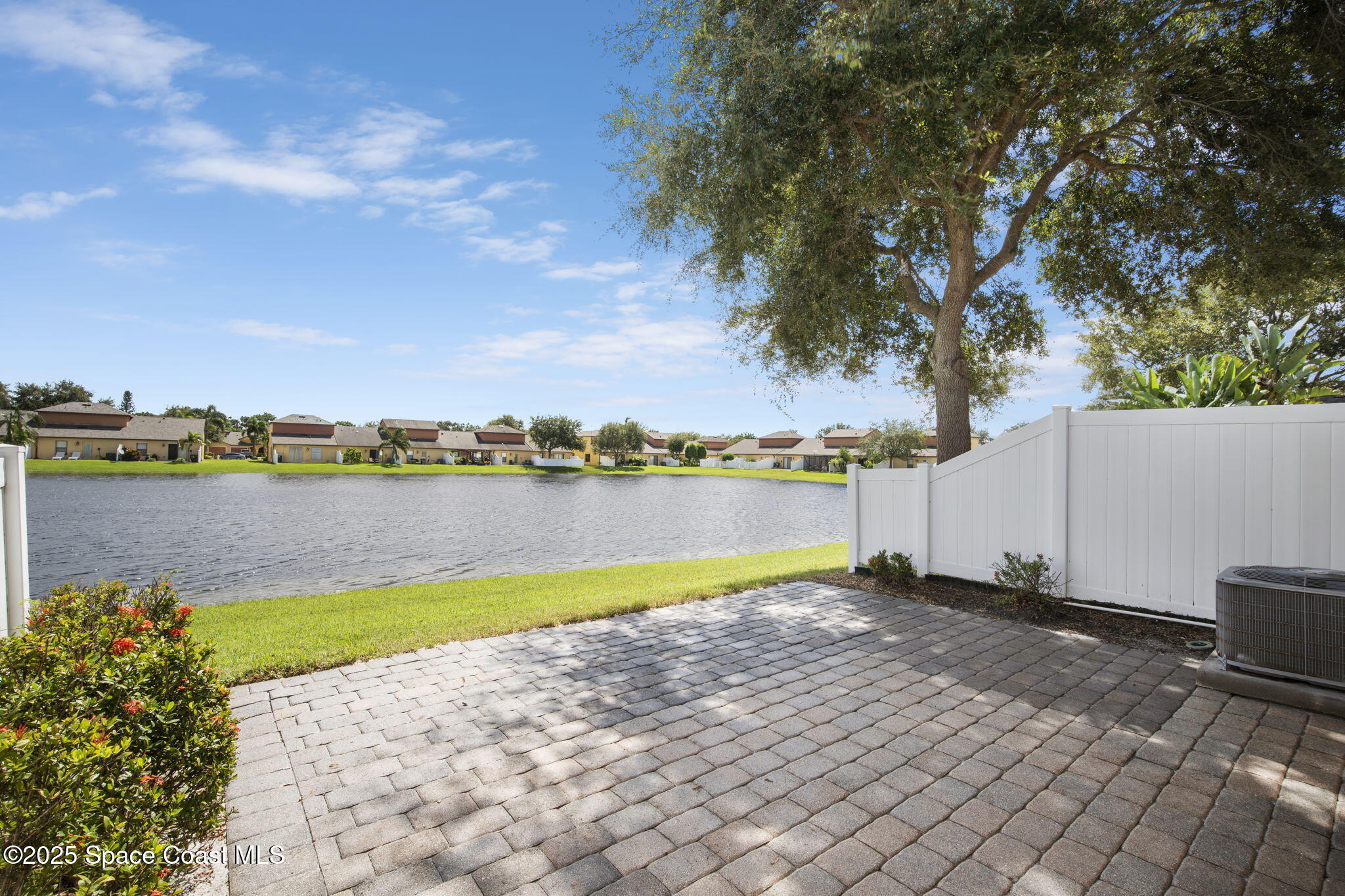 4575 Radiant Way, Unit 102 Melbourne, FL 32901 - Photo 13 of 52 a view of a lake with a yard