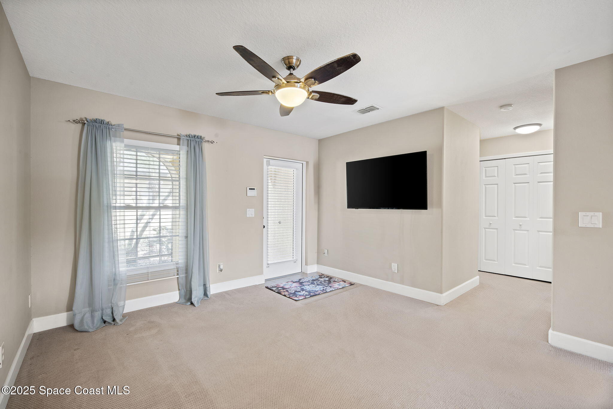 4575 Radiant Way, Unit 102 Melbourne, FL 32901 - Photo 16 of 52 a view of a livingroom with a flat screen tv
