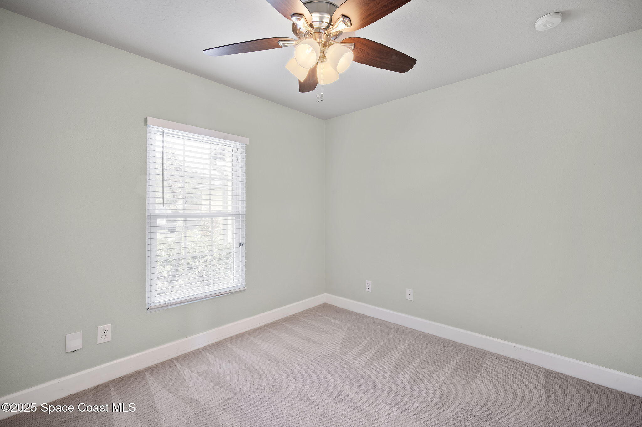 4575 Radiant Way, Unit 102 Melbourne, FL 32901 - Photo 20 of 52 an empty room with windows and fan