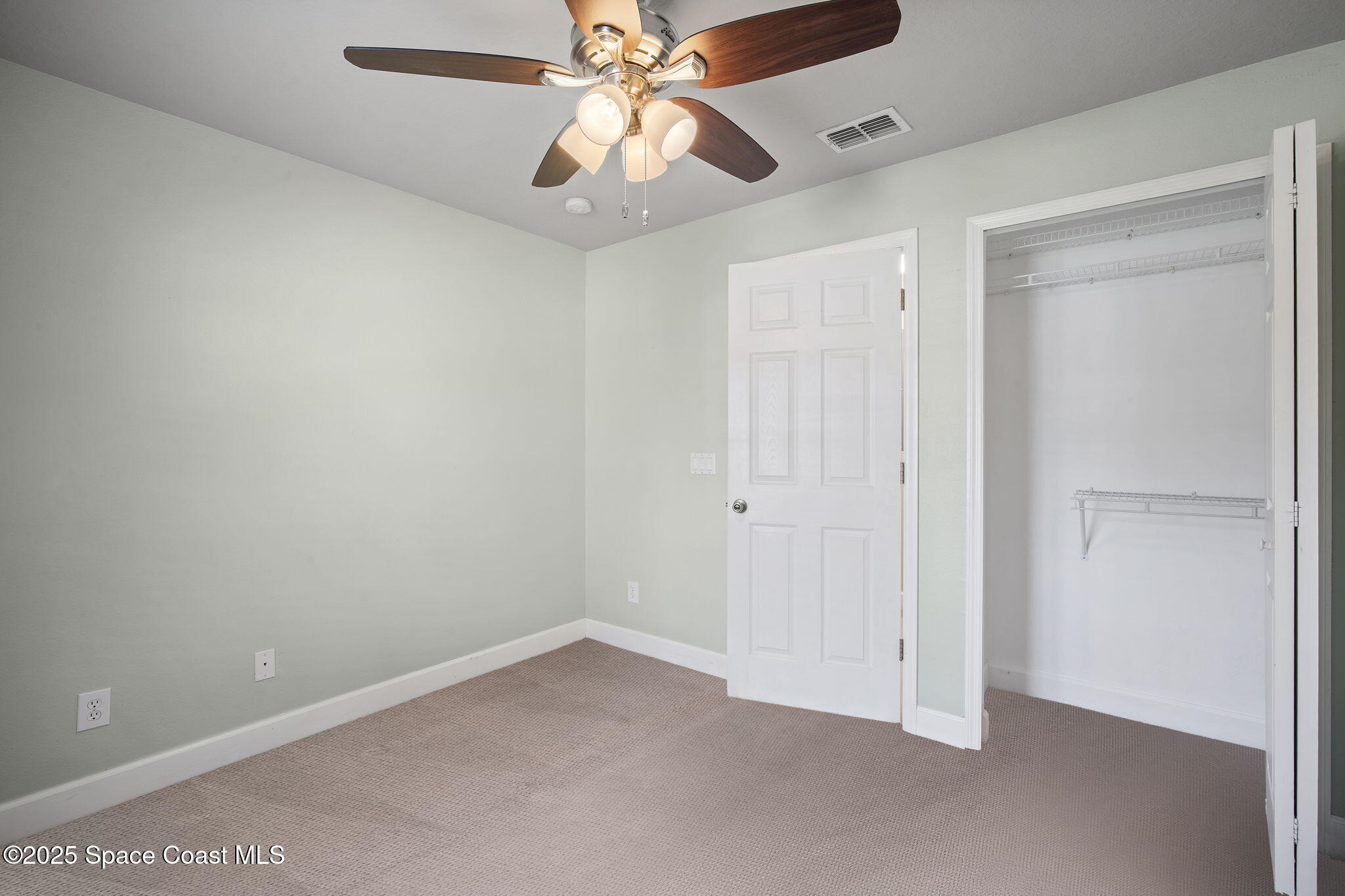 4575 Radiant Way, Unit 102 Melbourne, FL 32901 - Photo 21 of 52 an empty room with a window and a fan