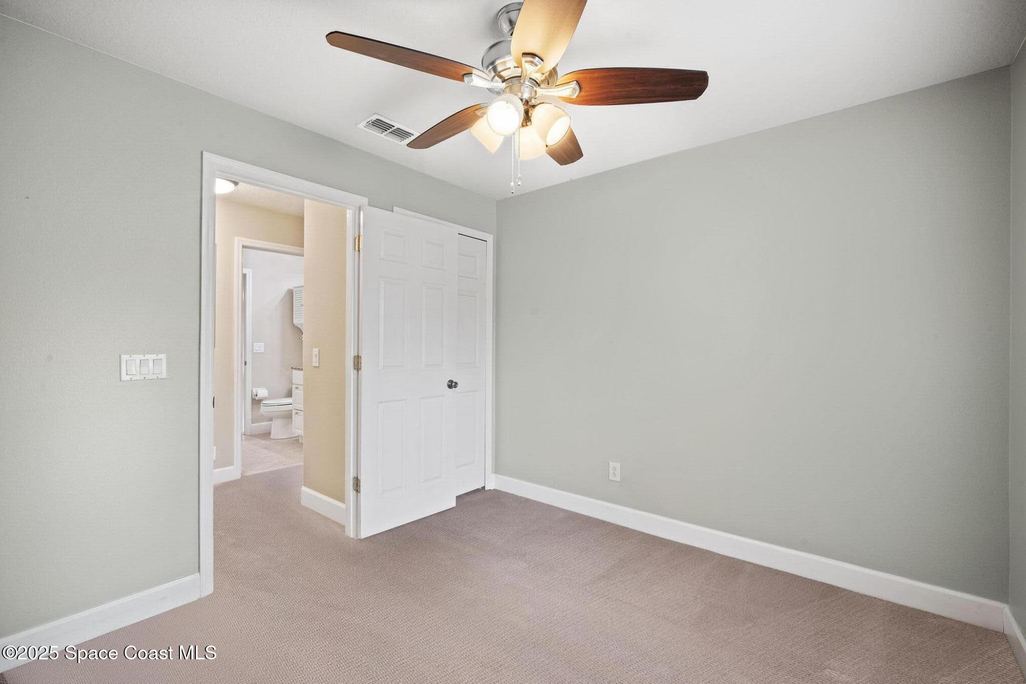 4575 Radiant Way, Unit 102 Melbourne, FL 32901 - Photo 22 of 52 an empty room with closet and a ceiling fan