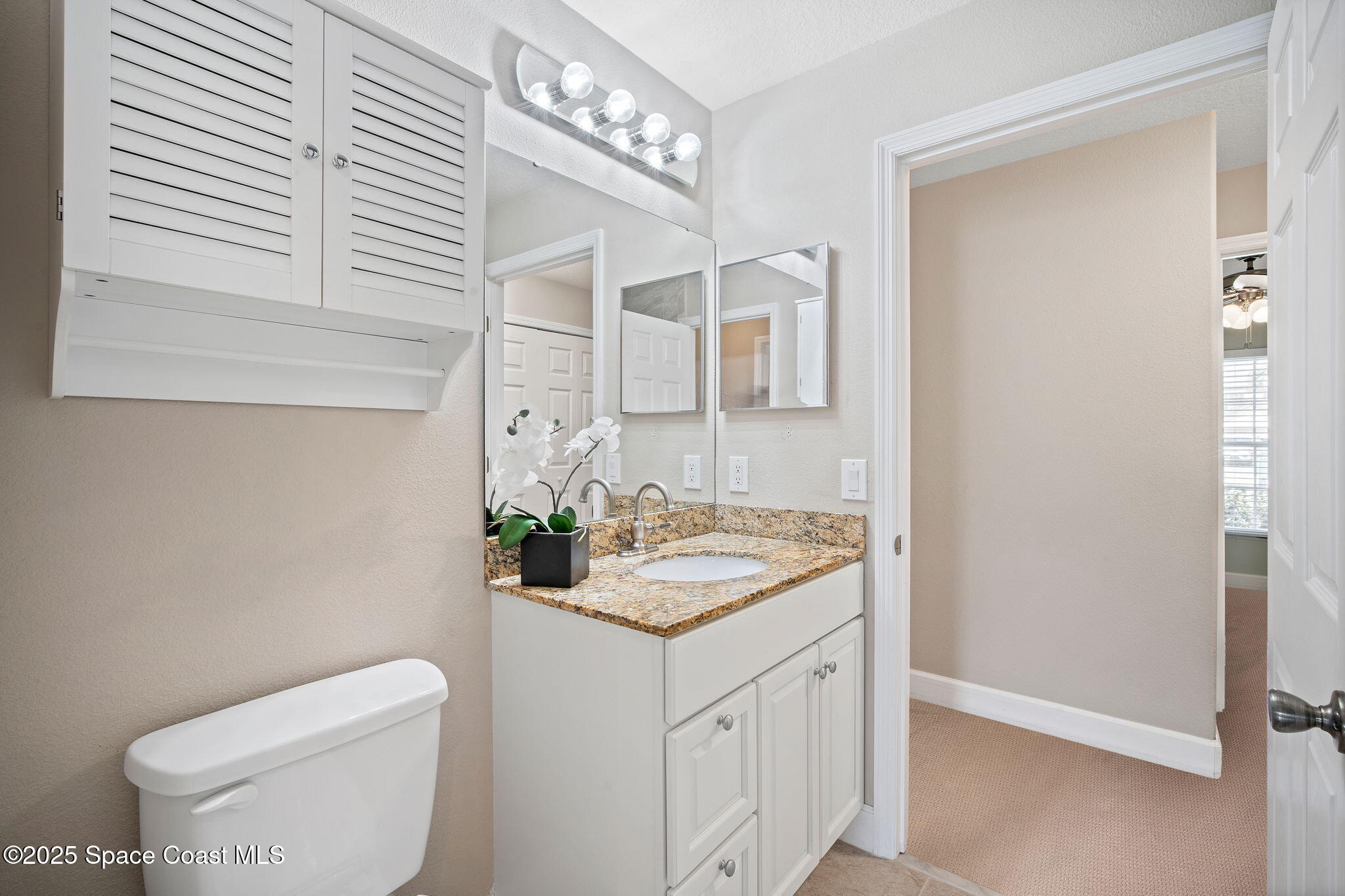 4575 Radiant Way, Unit 102 Melbourne, FL 32901 - Photo 26 of 52 a bathroom with a granite countertop sink and a toilet