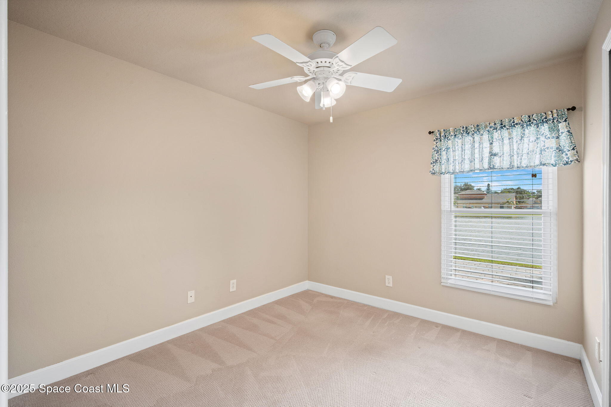 4575 Radiant Way, Unit 102 Melbourne, FL 32901 - Photo 28 of 52 a view of an empty room with a window