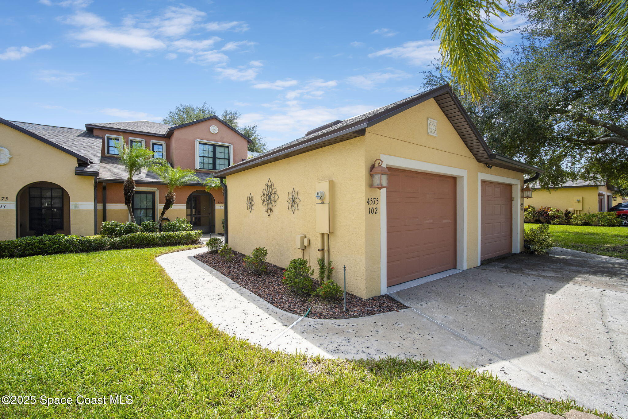 4575 Radiant Way, Unit 102 Melbourne, FL 32901 - Photo 3 of 52 a front view of house with yard