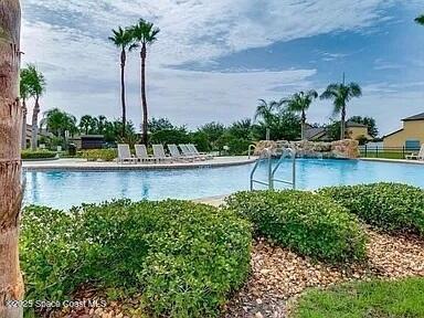 4575 Radiant Way, Unit 102 Melbourne, FL 32901 - Photo 44 of 52 a view of a lake with a palm and palm trees