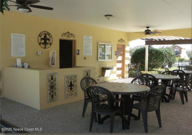 4575 Radiant Way, Unit 102 Melbourne, FL 32901 - Photo 46 of 52 a view of a dining room with furniture and a large window