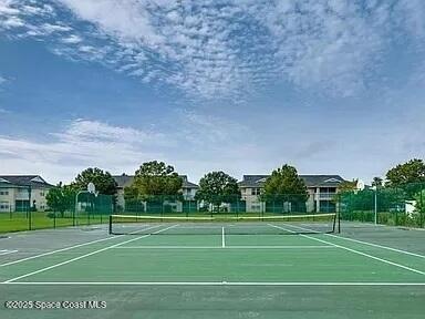 4575 Radiant Way, Unit 102 Melbourne, FL 32901 - Photo 48 of 52 a tennis court with trees in the background