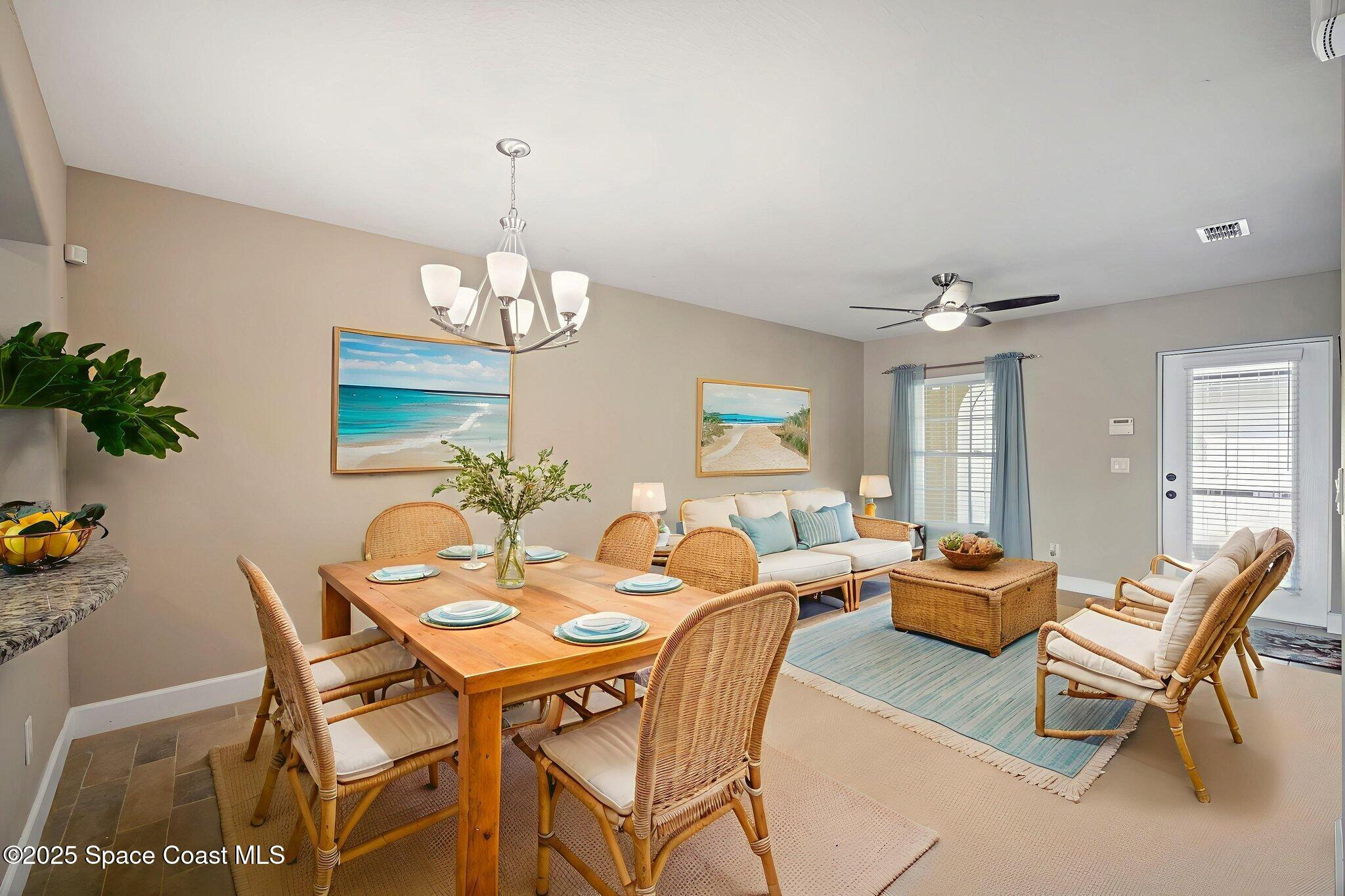 4575 Radiant Way, Unit 102 Melbourne, FL 32901 - Photo 7 of 52 a dining room with wooden floor a chandelier a glass table and chairs