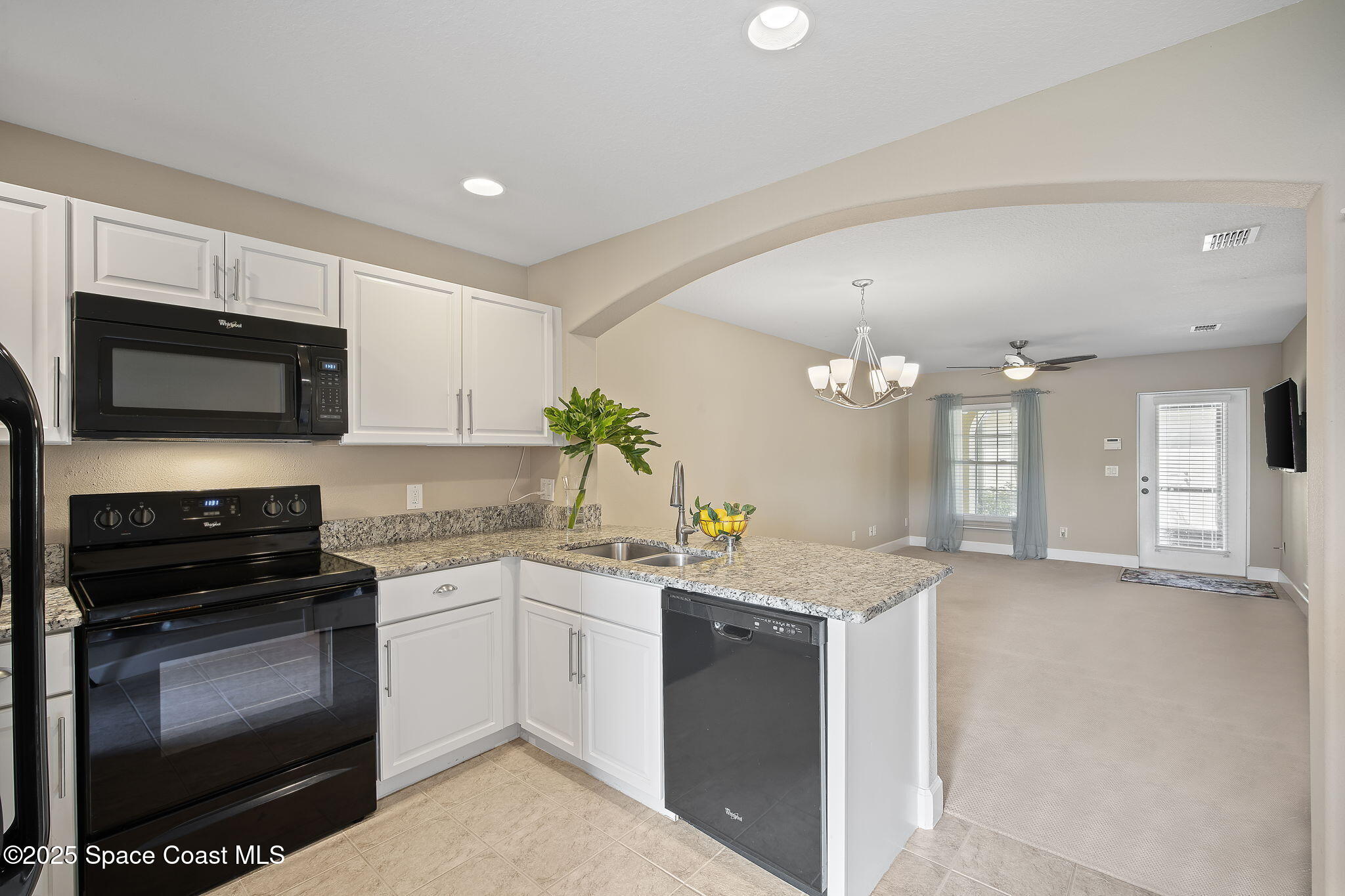 4575 Radiant Way, Unit 102 Melbourne, FL 32901 - Photo 9 of 52 a kitchen with a sink stove and microwave