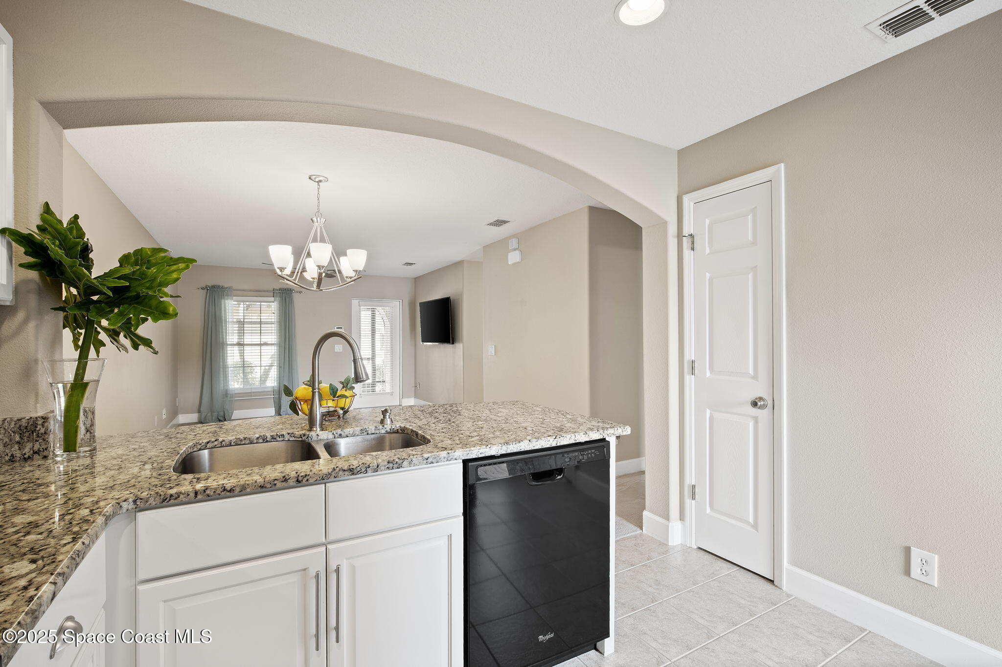 4575 Radiant Way, Unit 102 Melbourne, FL 32901 - Photo 10 of 52 a view of living room with granite countertop furniture and a chandelier