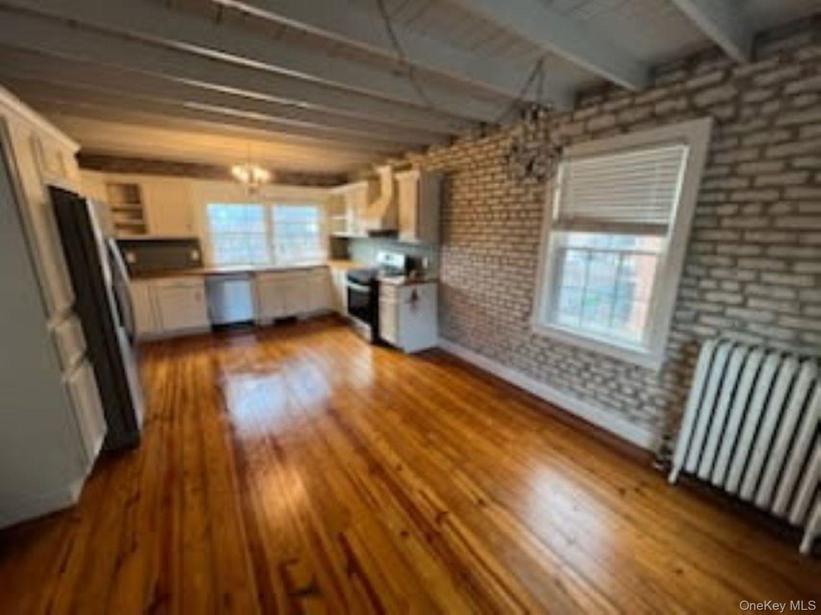 205 Union Street, Unit 2 Poughkeepsie, NY 12601 - Photo 14 of 16 a view of a room with wooden floor and furniture