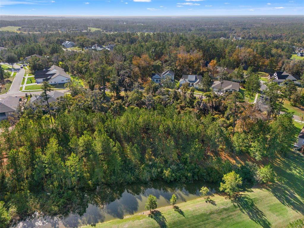 6633 Summit View Drive Brooksville, FL 34601 - Photo 3 of 16 an aerial view of a houses with a lush green hillside