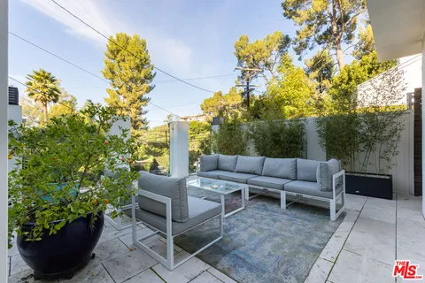 a view of a patio with couches and potted plants