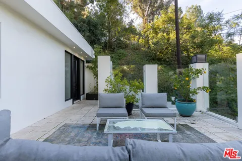 a view of a patio with couches and potted plants