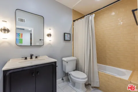 a bedroom with a bed and a mirror