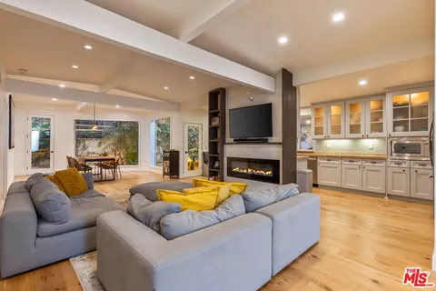 a living room with fireplace furniture and a flat screen tv