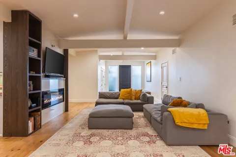 a living room with furniture and a lamp