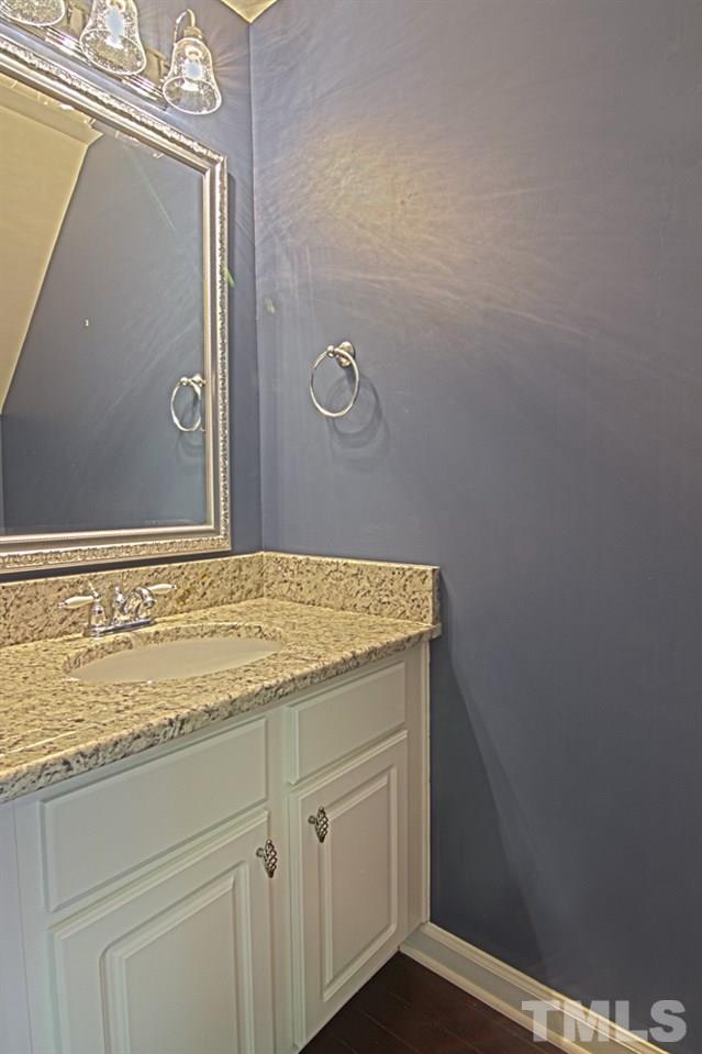 1624 Brook Fern Way Raleigh, NC 27609 - Photo 9 of 15 Downstairs powder room with granite countertops.
