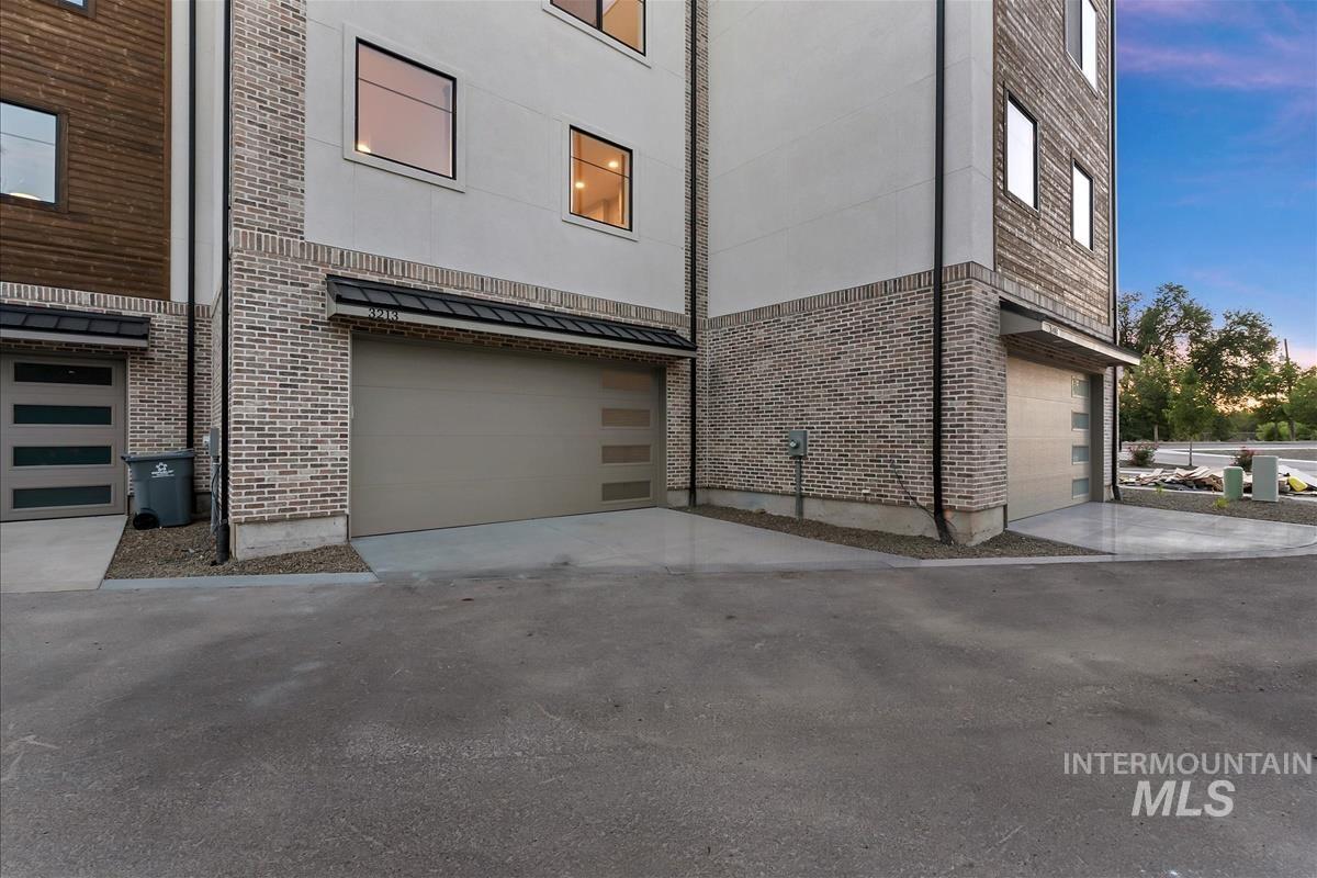 3213 West Moore Street Boise, ID 83702 - Photo 28 of 32 Contemporary exterior featuring light-toned brick and horizontal wood paneling