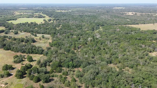 an aerial view of houses with yard