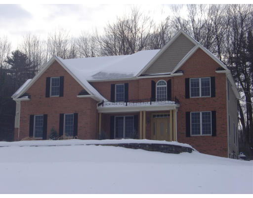 310 Old Wilson Road Northampton, MA 01062 - Photo 1 of 23 a front view of a house with a yard and garage