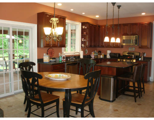 310 Old Wilson Road Northampton, MA 01062 - Photo 4 of 23 a dining room with a table chairs and a open kitchen view