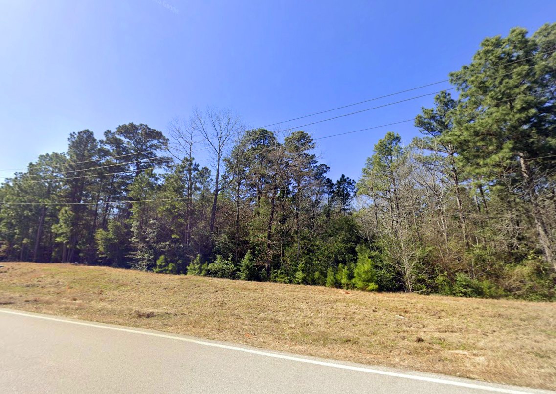 5-6-230 Dipping Vat Road Huntsville, TX 77340 - Photo 8 of 24 a view of large space with a house in the background