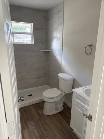 a bathroom with a toilet and a shower