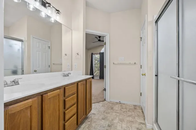 a bathroom with a sink vanity and mirror