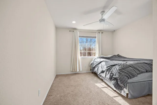 a bed sitting in a bedroom next to a window