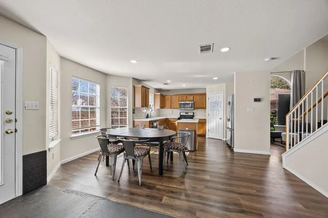 a view of a dining room with furniture window and wooden floor