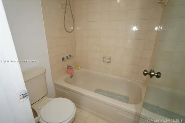 a bath room with a toilet and a bath tub