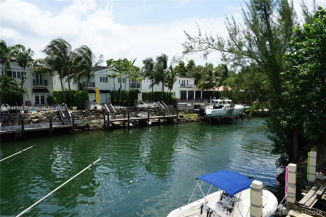a view of a lake with boats and trees in the background